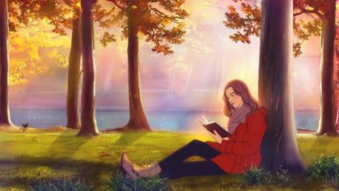 Una cristiana legge un libro sotto l'albero